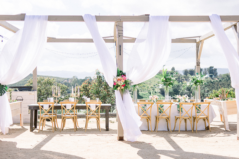 emerald-peak-temecula-wedding-reception-set-up-with-wooden-table-and-chairs-with-flowing-white-linens-around