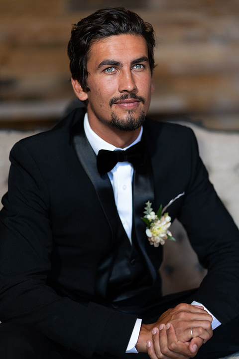 la-bonita-ranch-rustic-shoot-groom-sitting-looking-up-in-a-navy-shawl-lapel-tuxedo