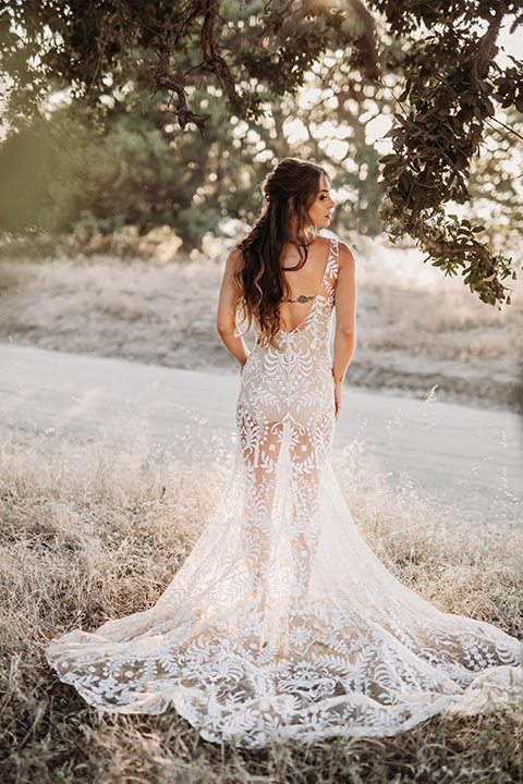 bride in a white bohemian style lace gown with a straps and a her hair in loose waves