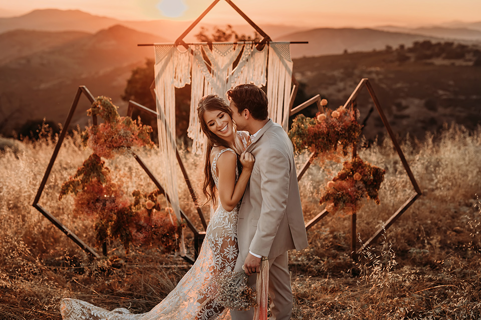  leave-her-wild-shoot-groom-kissing-bride-at-sunset