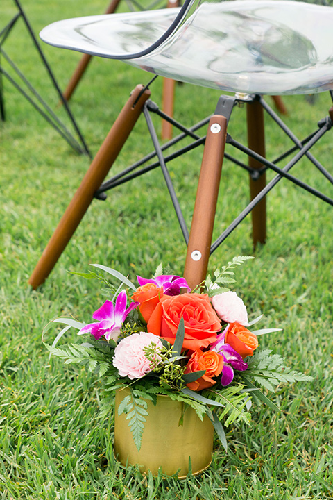 Ole-Hanson-Beach-Club-ceremony-décor-with-bright-florals-and-mid-century-style-chairs