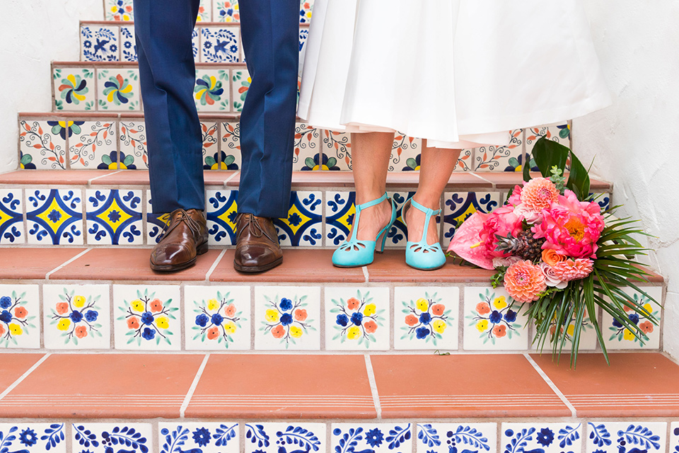 Ole-Hanson-Beach-Club-close-up-on-couples-foot-wear-the-groom-in-a-blue-suit-with-brown-shoes-and-the-bride-is-wearing-a-teal-heel-with-a-tea-length-gown