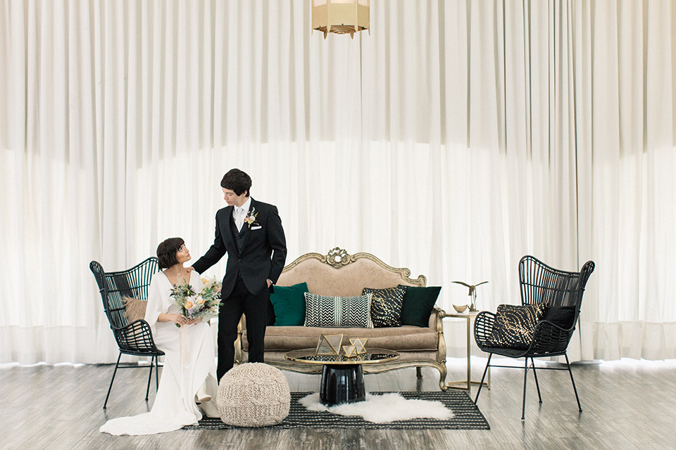 Modern-Mystical-Styled-shoot-at-the-york-bride-and-groom-in-reception-seating-area-bride-in-a-sheer-flowing-dress-with-a-silk-underlay-with-beading-and-groom-in-a-black-suit