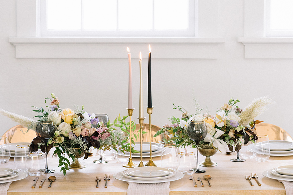 Modern-Mystical-Styled-shoot-at-the-york-table-decor-and-set-up-with-a-light-wooden-table-with-organic-florals-and-tall-candles