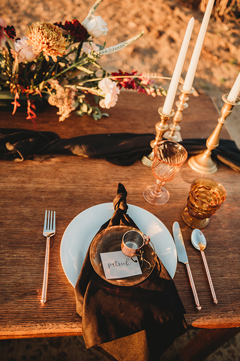 Moonflower-Ranch-Shoot-table-décor-with-gold-décor-and-white-tall-candles