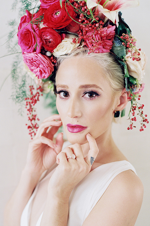 II-Mercato-in-New-Orleans-bride-with-florals-on-her-head-bride-in-a-fitting-minimalistic-dress-with-a-high-neckline-and-floral-crown-groom-in-a-green-suit-with-brown-shoes-and-floral-long-tie