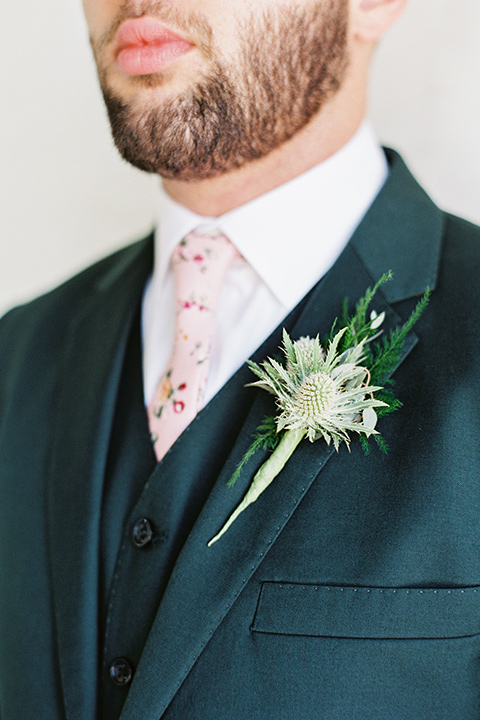 II-Mercato-in-New-Orleans-close-up-on-groom-attire-groom-in-a-green-suit-with-brown-shoes-and-floral-long-tie