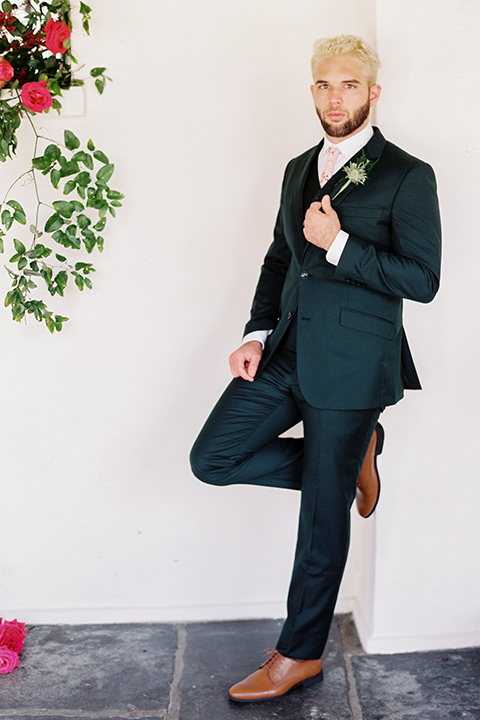 II-Mercato-in-New-Orleans-groom-standing-alone-groom-in-a-green-suit-with-brown-shoes-and-floral-long-tie