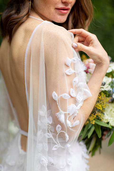 bridal gown close up with an illusion detail and floral design