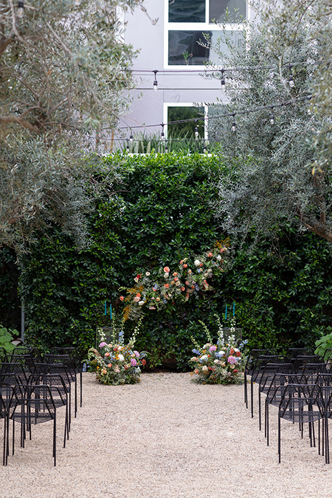 ceremony florals and black metal chairs