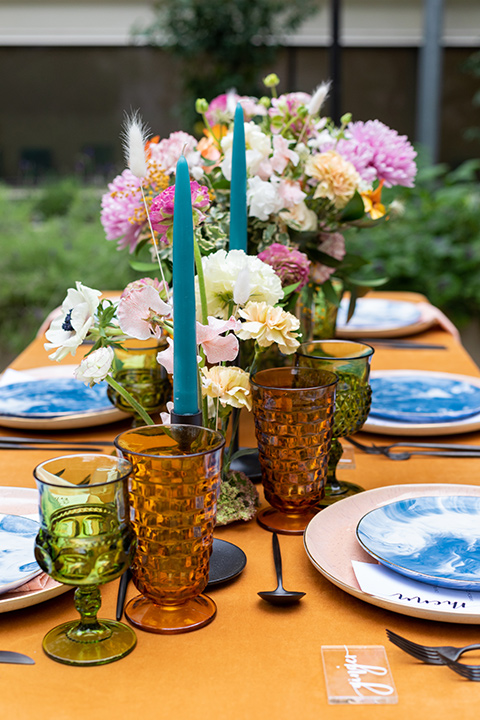 gold table cloth with white and blue table décor and gold flatware