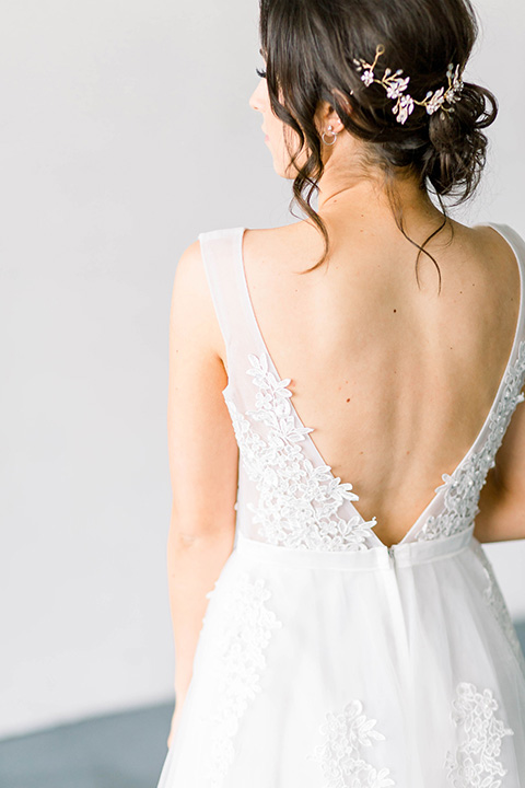 Spring-styled-shoot-bridal-gown-with-a-open-back-and-lace-cap-sleeves-and-soft-tulle-skirt