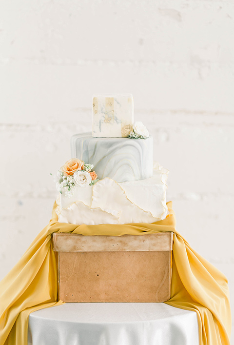 Spring-styled-shoot-cake-in-a-three-tier-style-with-light-blue-and-white-fondant-and-yellow-flowers