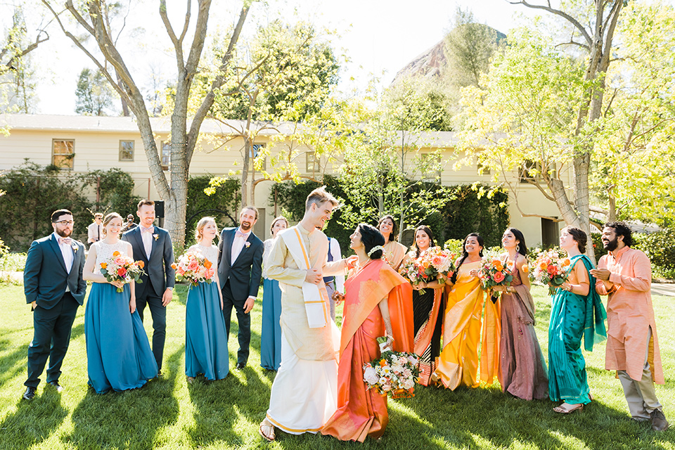 Supriya-and-Chris-wedding-bridal-party-for-indian-ceremony-the-bride-and-groom-in-traditional-dress-the-groomsmen-in-navy-suits-and-bridesmaids-in-different-style-of-dresses