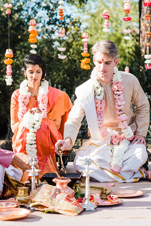 Supriya-and-Chris-wedding-bride-and-groom-sitting-at-indian-ceremony