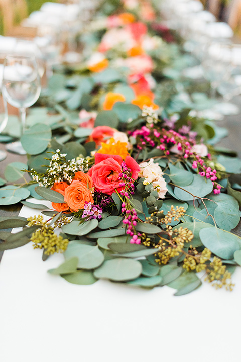 Supriya-and-Chris-wedding-table-centerpiece-with-sage-and-red-and-orange-flowers