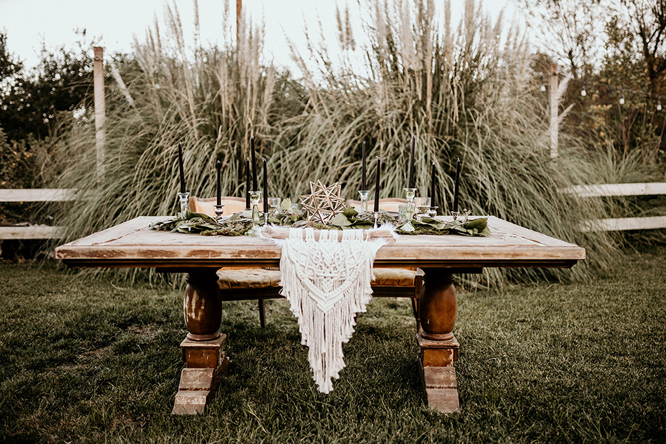 retro-ranch-styled-shoot-table-set-up-with-a-wooden-table-and-bohemian-inspired-plates-and-goldware