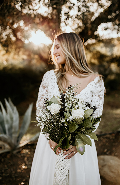 The-Retro-Ranch-Shoot-bride-wearing-a-flowing-gown-with-lace-long-sleeves