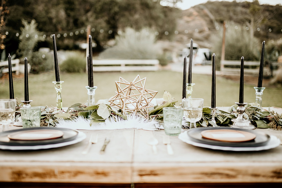 The-Retro-Ranch-Shoot-table-décor-with-tall-black-cendles-and-gold-accents