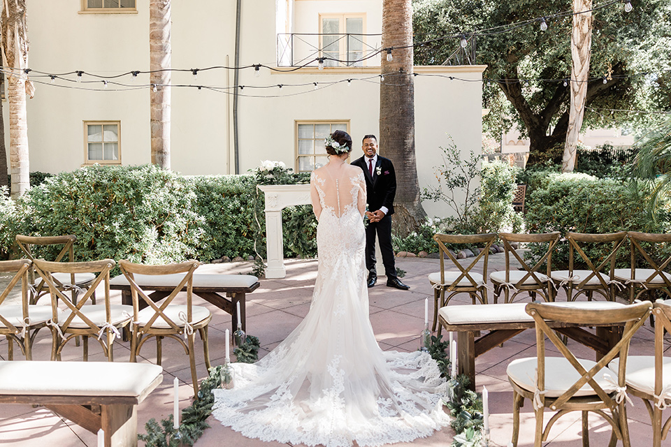 Maxwell-House-bride-walking-down-the-aisle-groom-waiting-bride-is-wearing-a-lace-long-sleeved-gown-groom-in-a-black-velvet-tuxedo