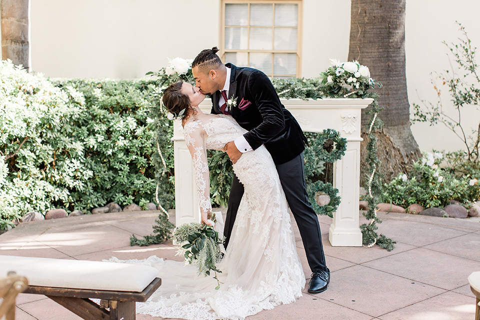 Maxwell-House-groom-dipping-bride-bride-is-wearing-a-lace-long-sleeved-gown-groom-in-a-black-velvet-tuxedo