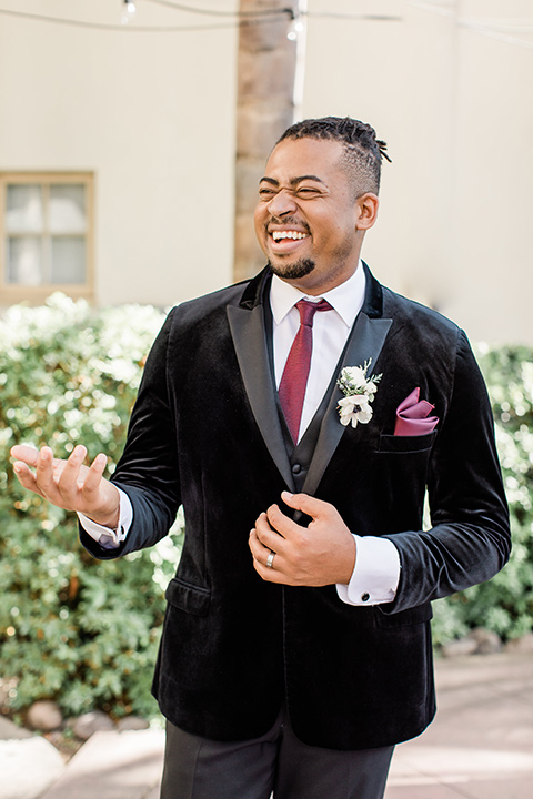 Maxwell-House-groom-laughing-in-a-black-velvet-tuxedo-and-a-red-long-tie