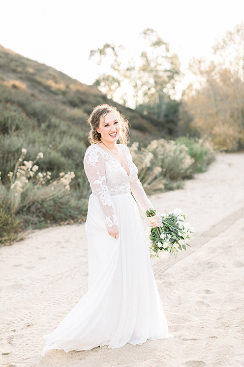 community-church-wedding-bride-smiling-at-camera-bride-in-a-flowing-boho-style-dress-with-sleeves