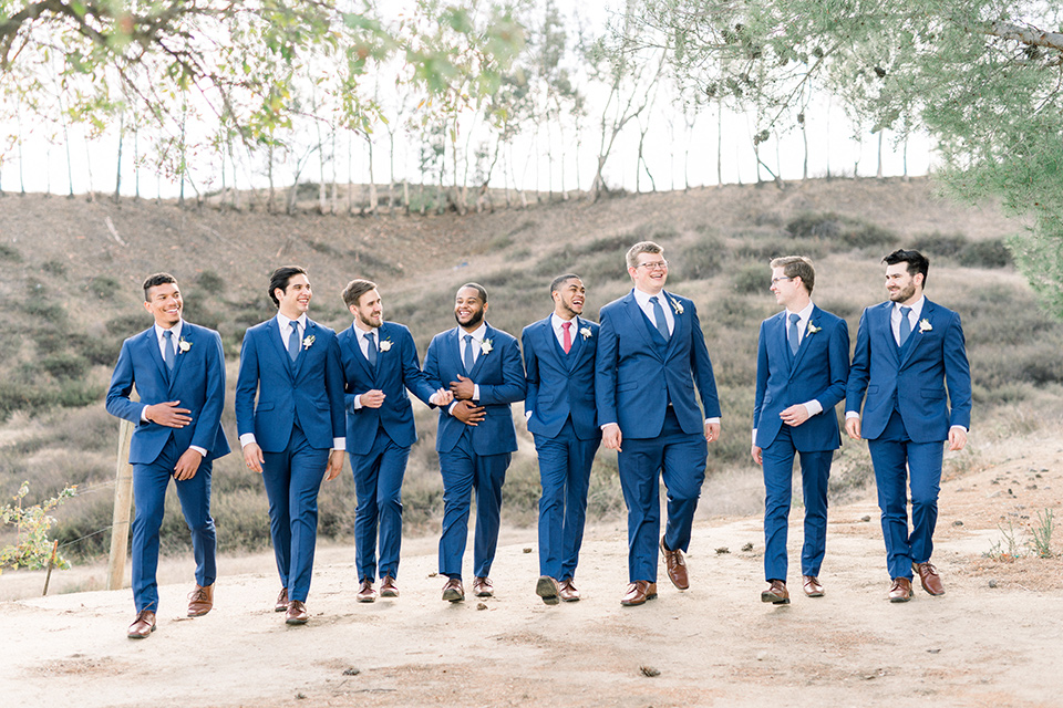 community-church-wedding-groomsmen-walking-in-cobalt-blue-suits-groomsmen-with-blue-ties-groom-with-a-berry-colored-tie