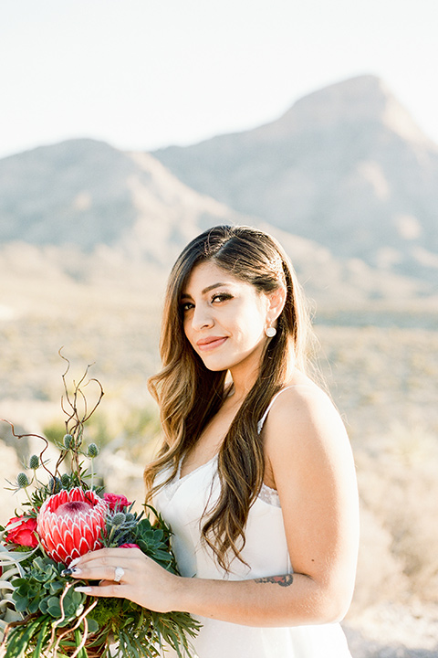 red-rocks-shoot-bride-alone-bride-in-a-flowing-white-gown-groom-in-a-grey-suit