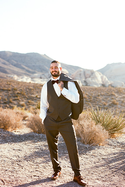 red-rocks-shoot-goom-standing-alone-groom-in-a-grey-suit