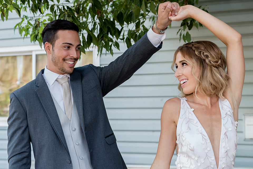 Blossom-valley-victorian-wedding-shoot-bride-and-groom-dancing-bride-weaing-a-flowing-gown-with-straps-and-groom-wore-a-mix-and-match-look-with-a-dark-grey-coat-and-light-grey-pants