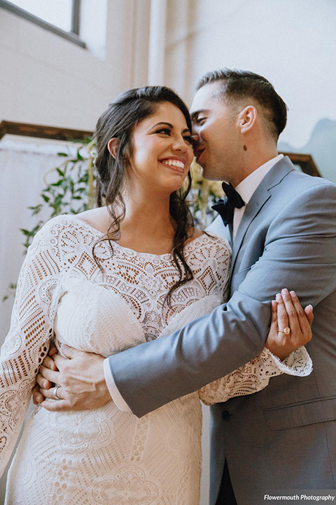 gather-venues-bride-and-groom-hugging-groom-in-blue-suit-bride-in-bohemian-dress