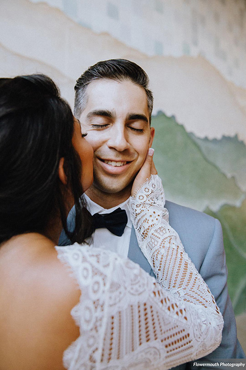 gather-venues-bride-and-groom-at-ceremony-bride-wearing-a-bohemian-lace-gown-with-sleeves-while-the-groom-wore-a-light-blue-suit-coat-with-dark-blue-suit-pants