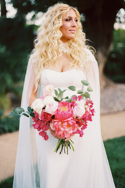  bride in a vintage bohemian gown with beaded details and cape 