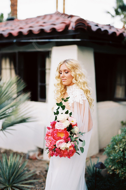  bride in a vintage bohemian gown with beaded details and cape