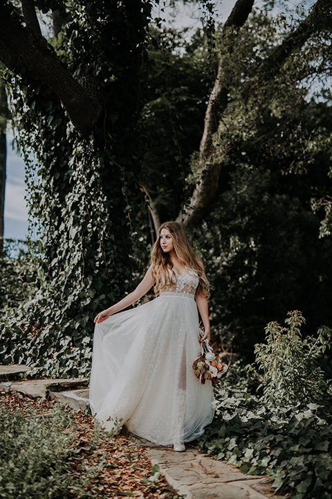  bride in a bohemian lace gown with a tulle skirt, lace boots 