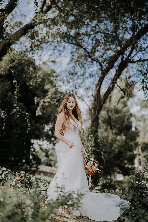  bride in a bohemian lace gown with a tulle skirt, lace boots 