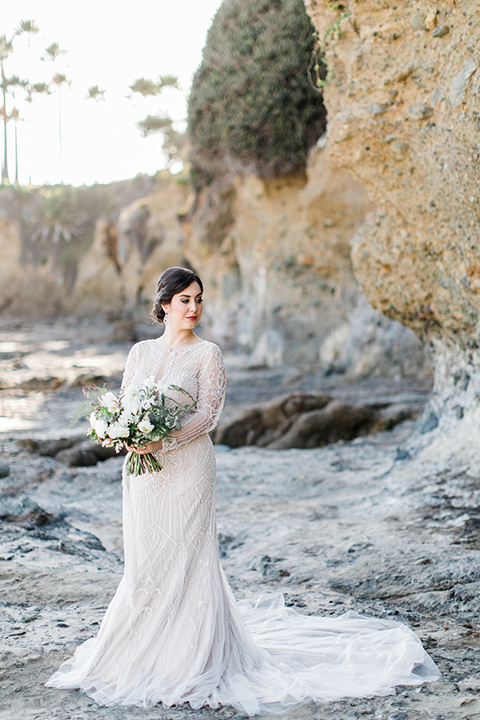 bride in a flowing gown with an illusion neckline and hair in a soft updo with a crystal pin detail