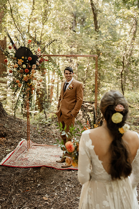  formfitting bridal lace gown with sleeves and the groom in a caramel suit with long tie