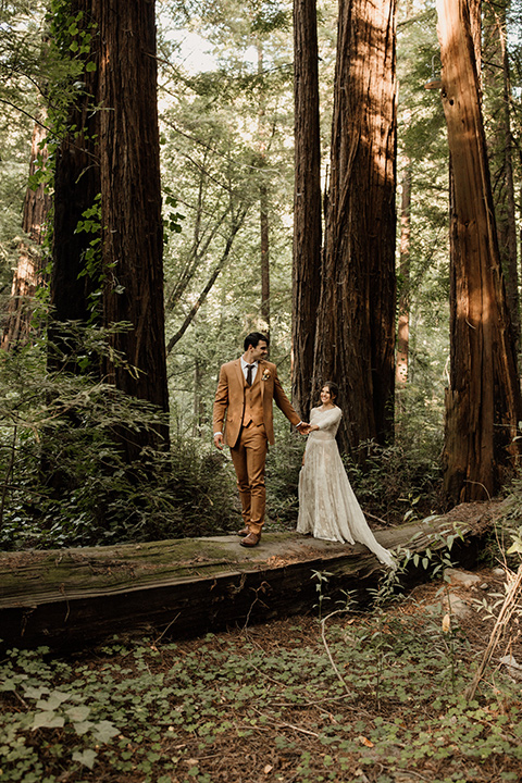  formfitting bridal lace gown with sleeves and the groom in a caramel suit with long tie