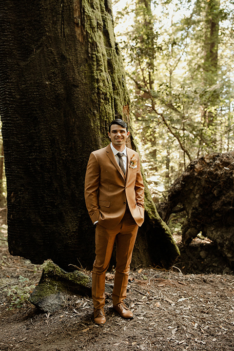  formfitting bridal lace gown with sleeves and the groom in a caramel suit with long tie