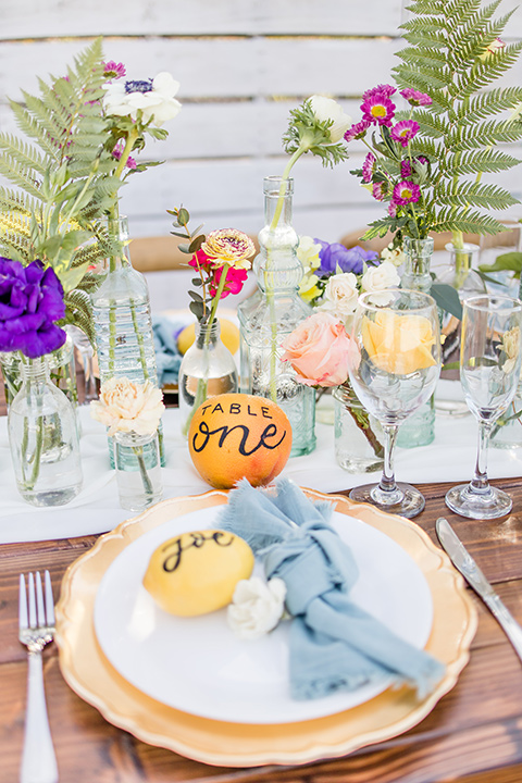  farmhouse table with orange and white flatware 