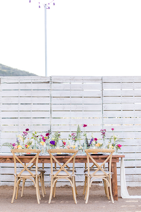  farmhouse table with white and orange flatware and gold details 