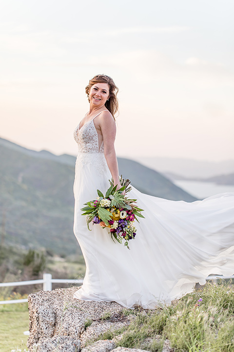  bride in a lace gown with thin straps and beaded bodice 