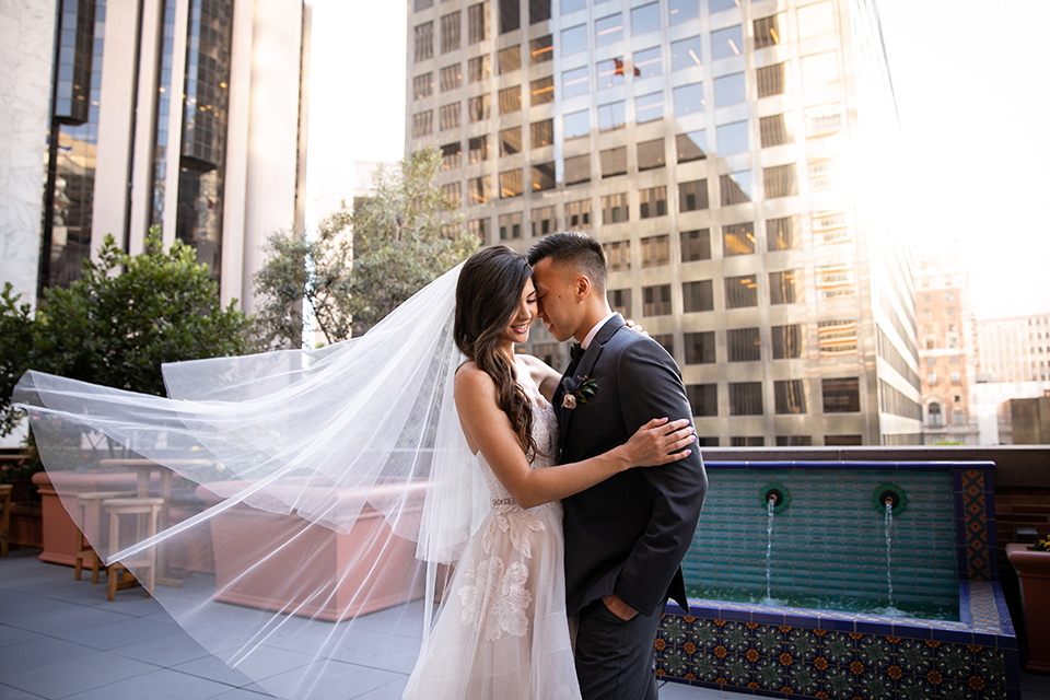  bride in a modern ballgown with a strapless neckline, groom in a charcoal grey suit with a black bow tie 