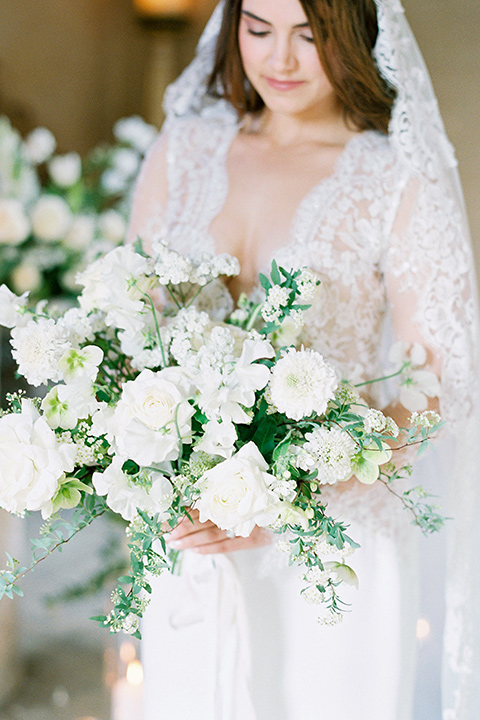  bride in a white lace ballgown with long sleeves and a v-neckline 