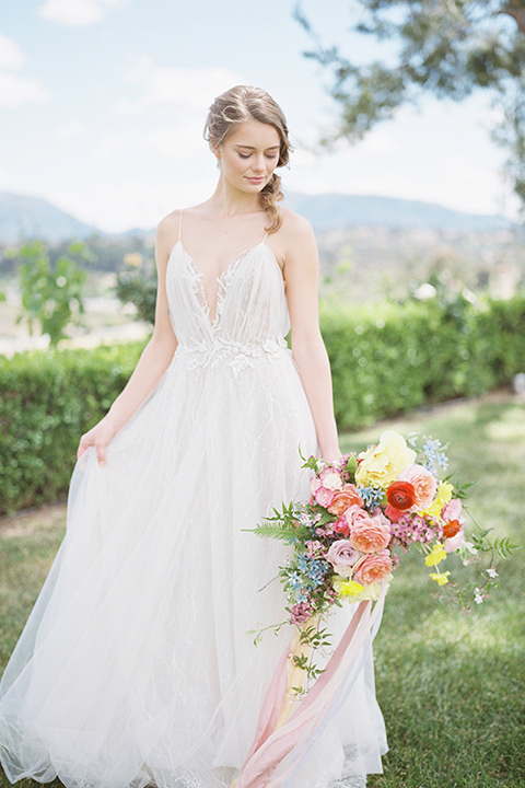  bride in a white flowing gown with a v neckline 