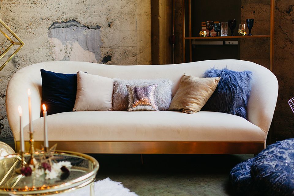  couch with purple and blue pillows 