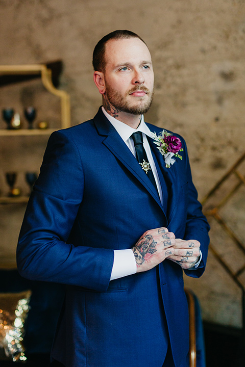  bride in groom in a cobalt blue suit and a black long tie 