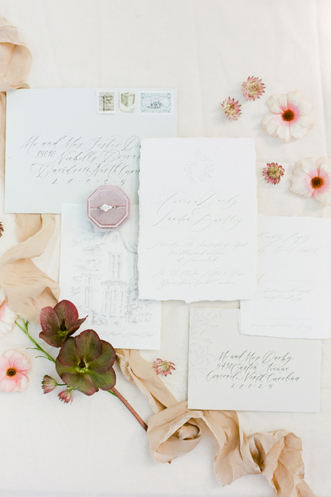  white invitations with gold calligraphy design